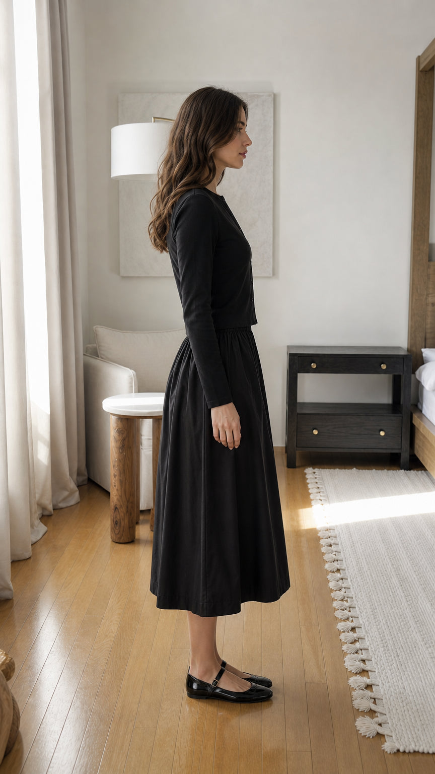 Woman wearing black two-piece set, side view