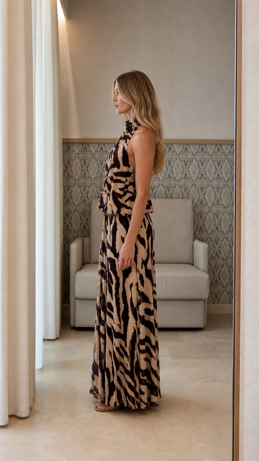Side profile view of beige animal print maxi dress