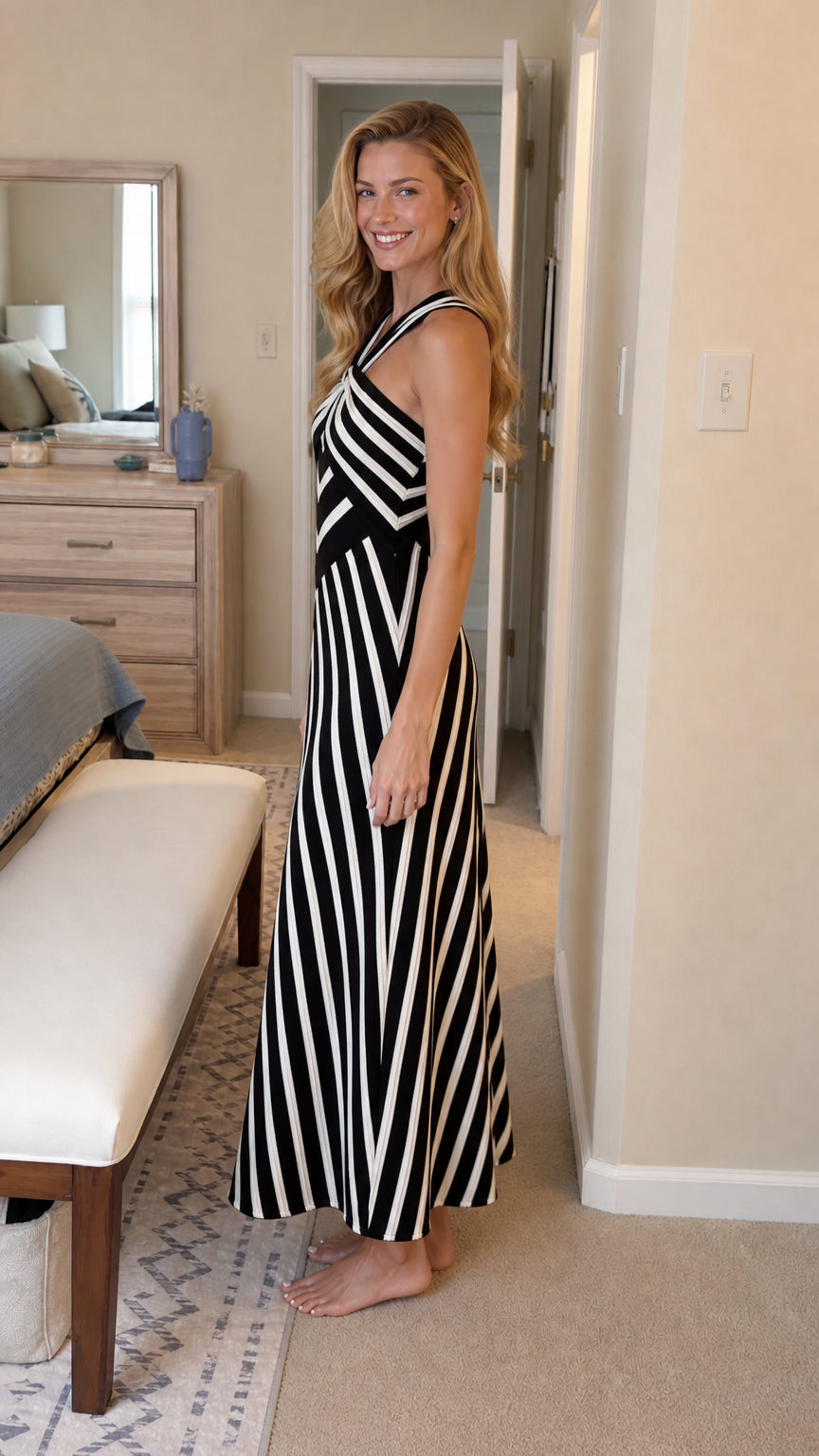 Side profile view of black and white striped maxi dress