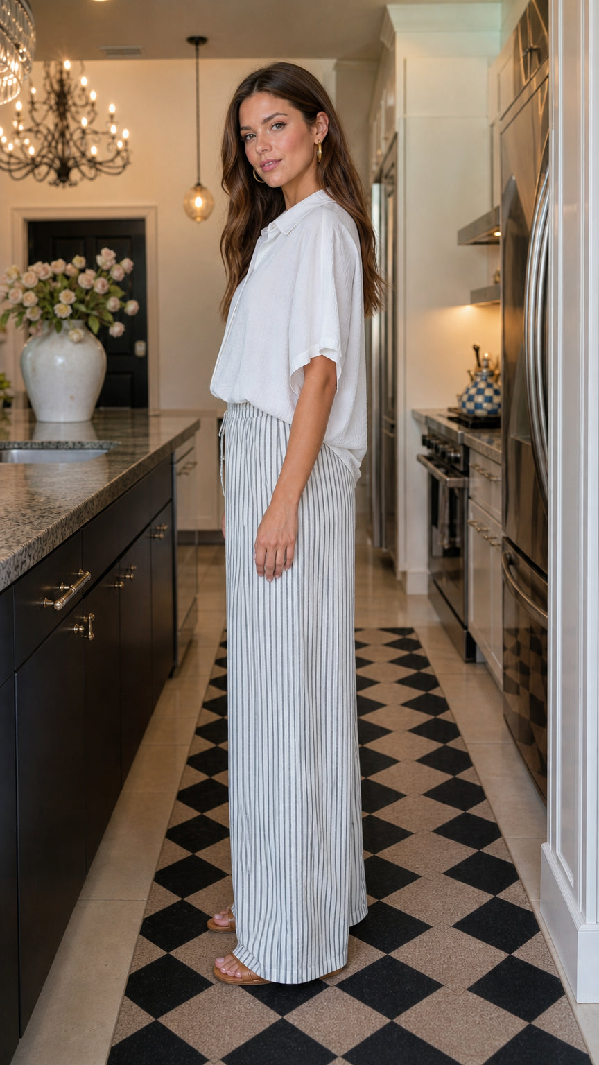 Woman wearing white shirt and striped pants set side view