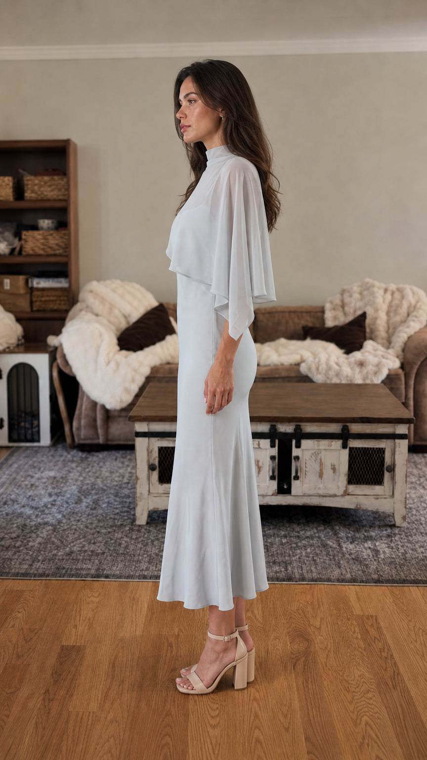 Side profile view of light blue cape midi dress