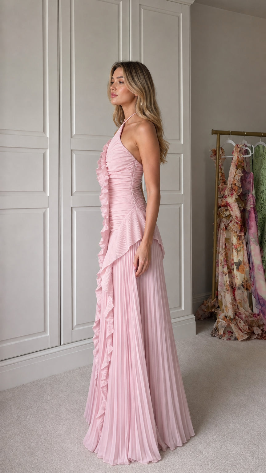 Side profile of model in pink pleated maxi dress