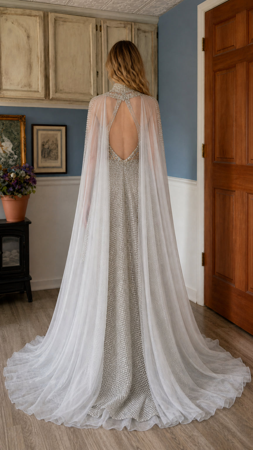 Back view showcasing sheer cape and low-back detail