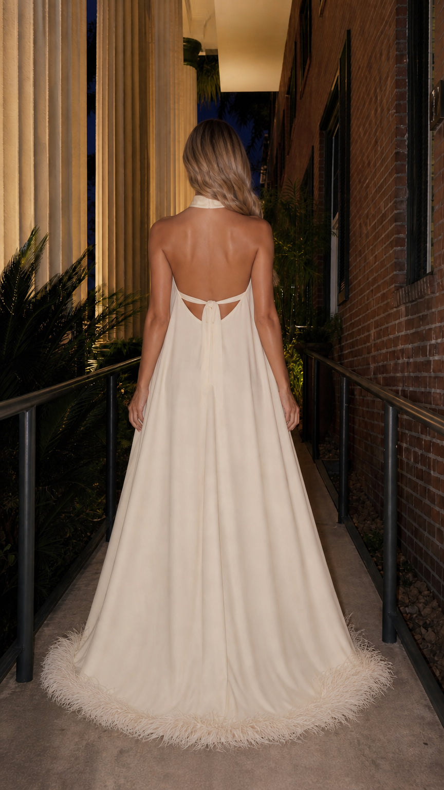 Back view showcasing open back and train of ivory maxi dress