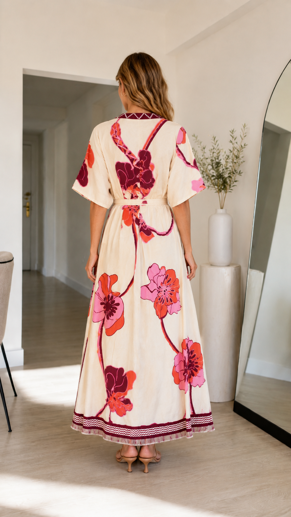 Back view of cream floral print maxi dress with short sleeves and full-length hem