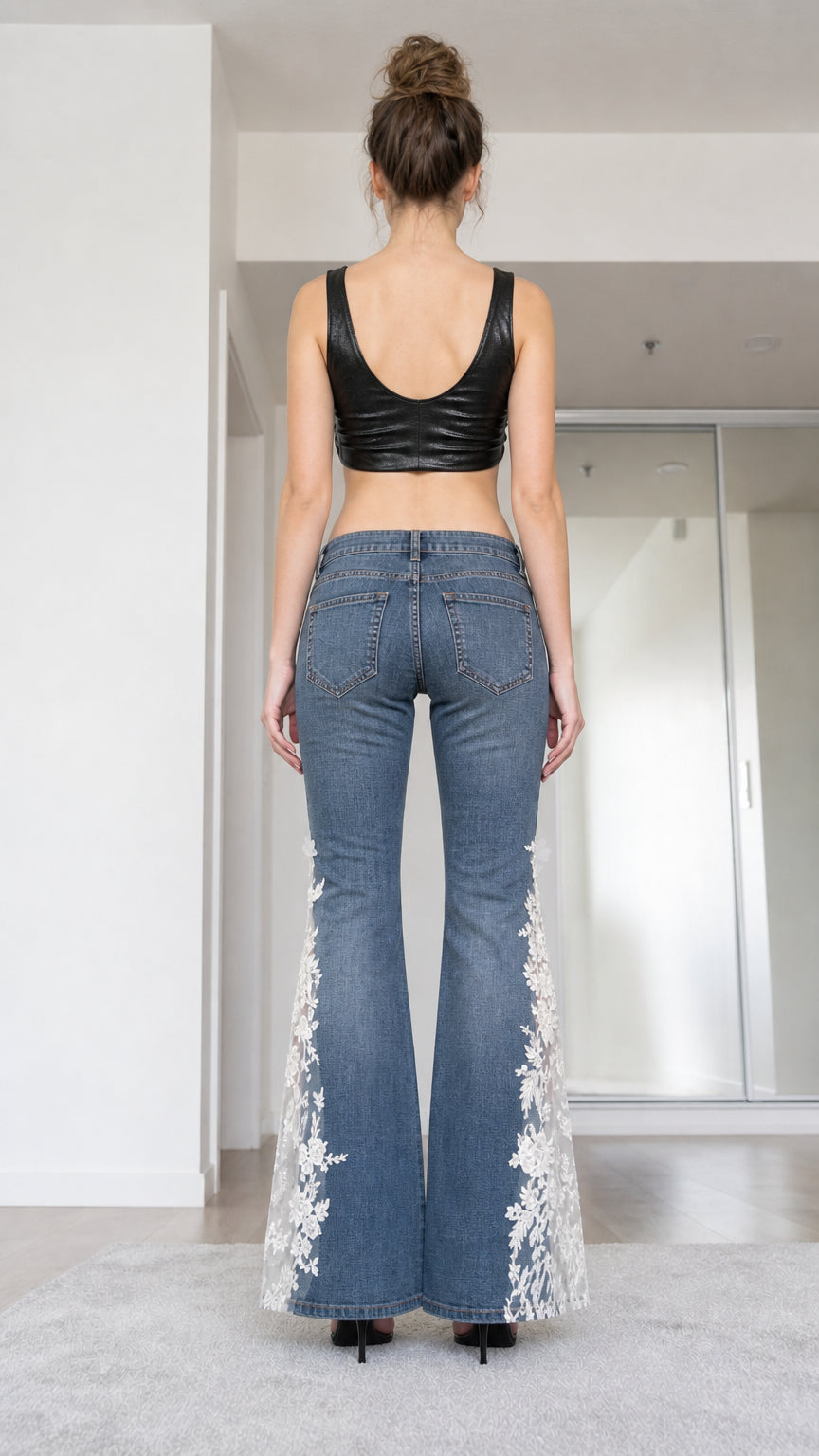 Back view of woman wearing blue flare jeans with lace hem details