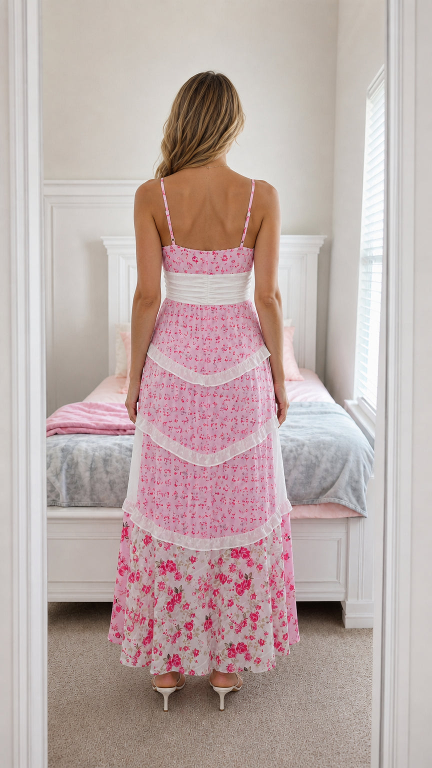 Back view of model wearing pink floral maxi dress with spaghetti straps