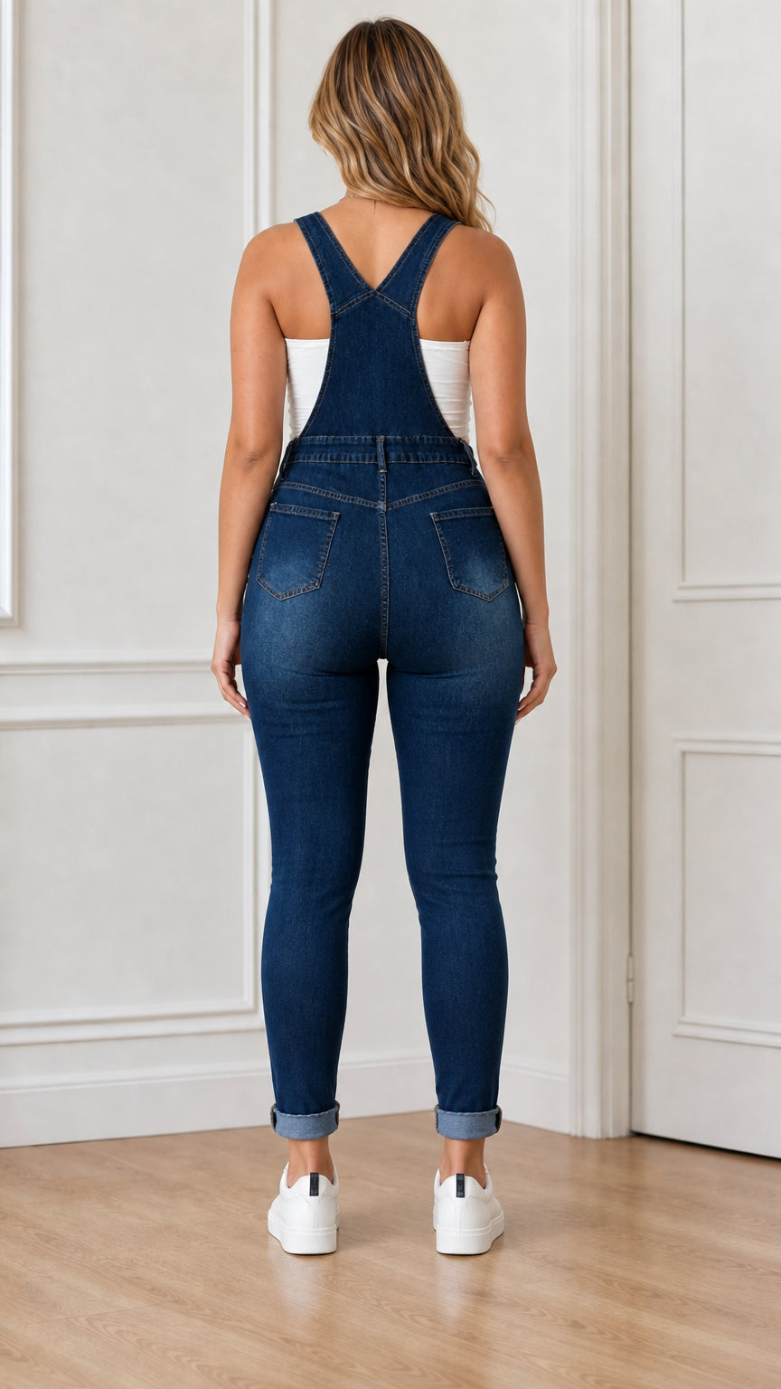 Back view of woman wearing blue denim overalls