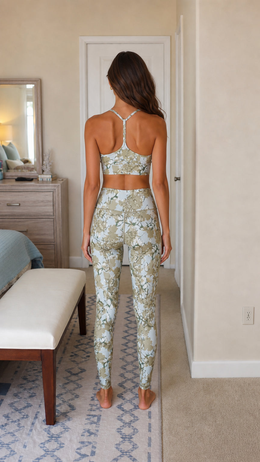 Model wearing sage green floral athletic set back view