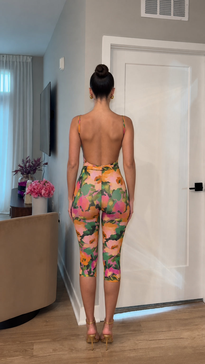 Back view showcasing open back design of multi floral jumpsuit