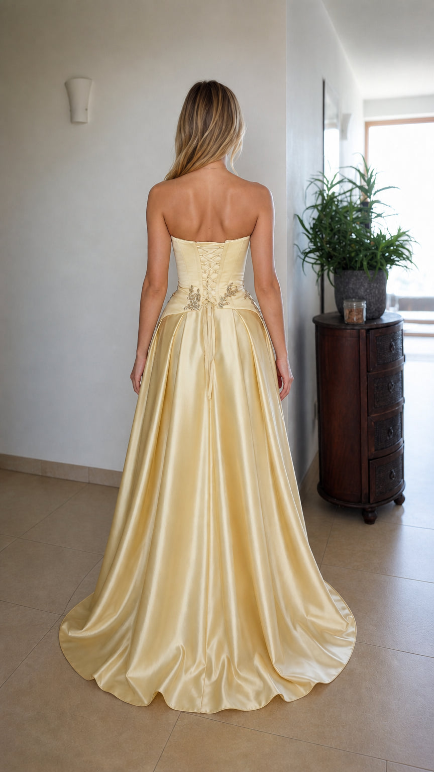 Back view showing lace-up corset detail on champagne dress