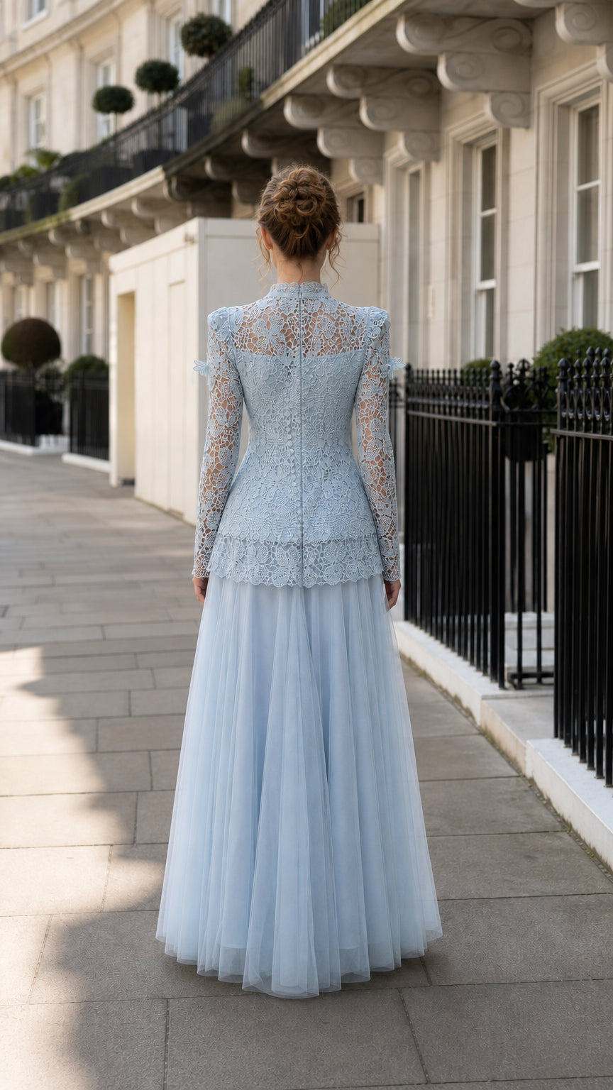 Back view showing the structured lace bodice and flowing skirt