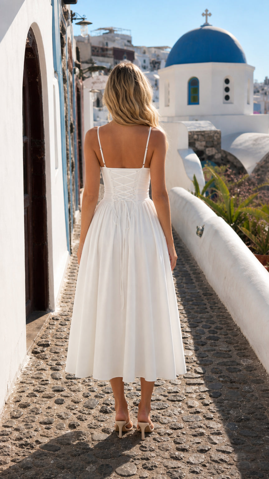 Back view showcasing lace-up detail on white midi dress