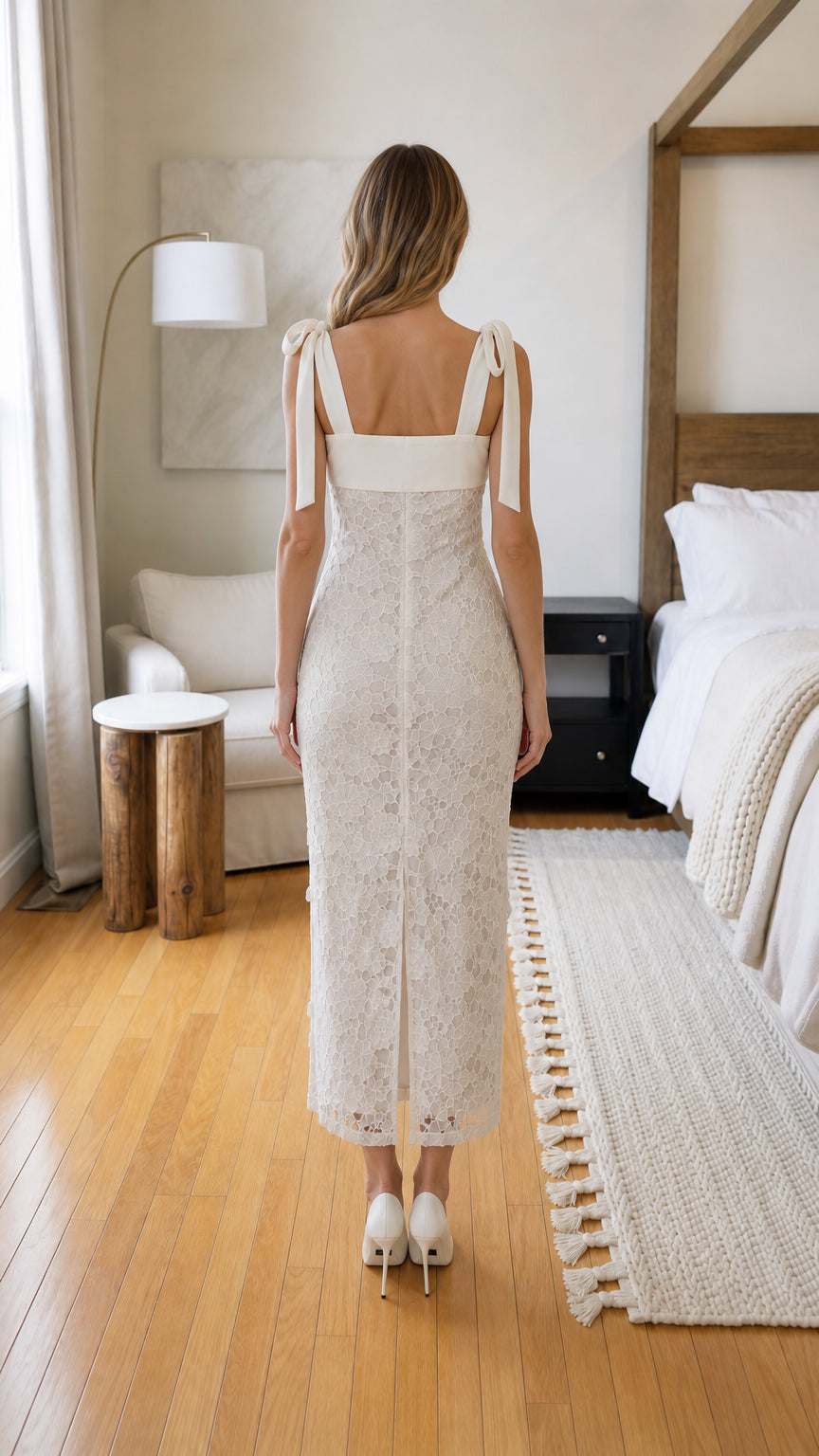 Back view of woman wearing white lace midi dress