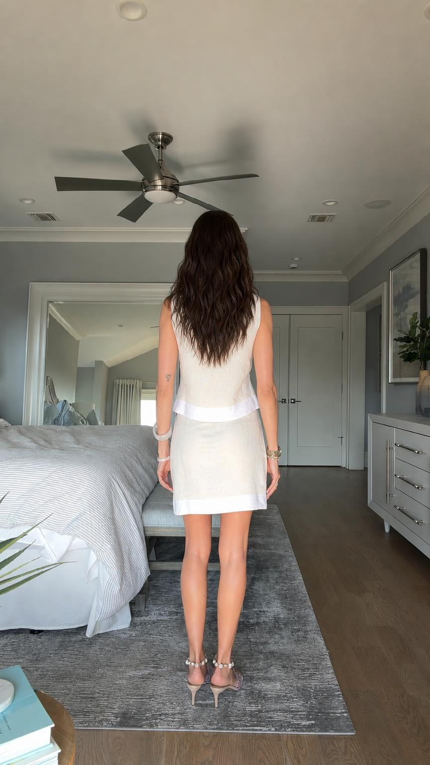 Back view of model in beige two-piece outfit