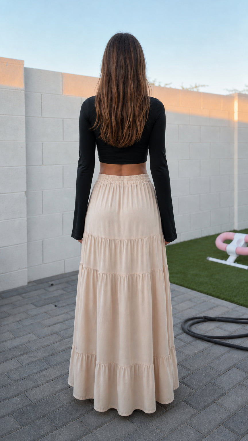 Back view of model in beige tiered maxi skirt