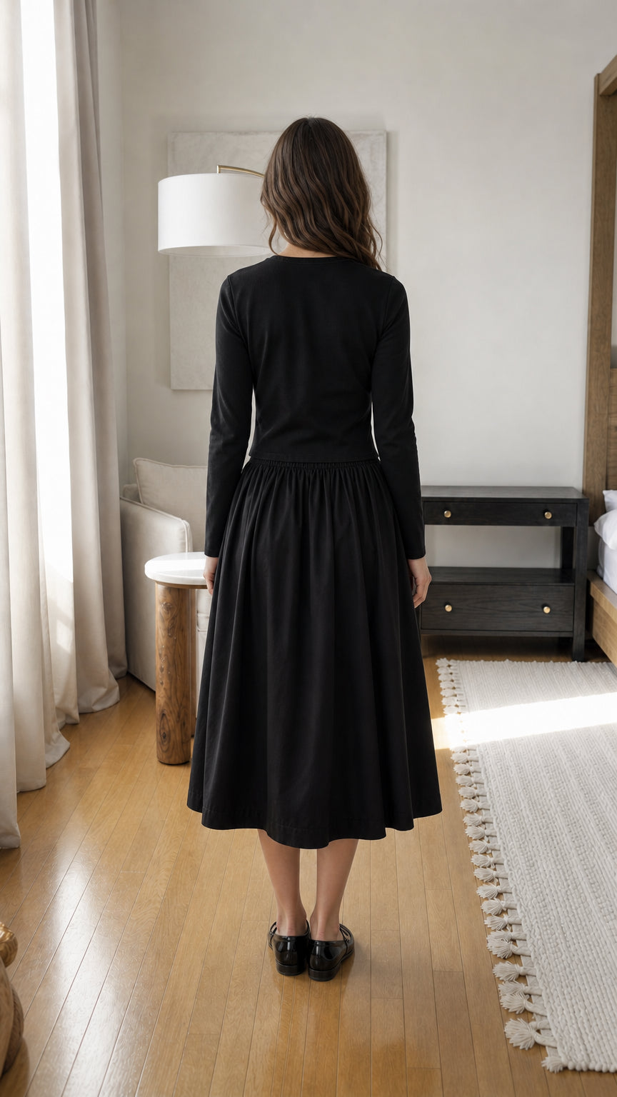 Woman wearing black two-piece set, back view