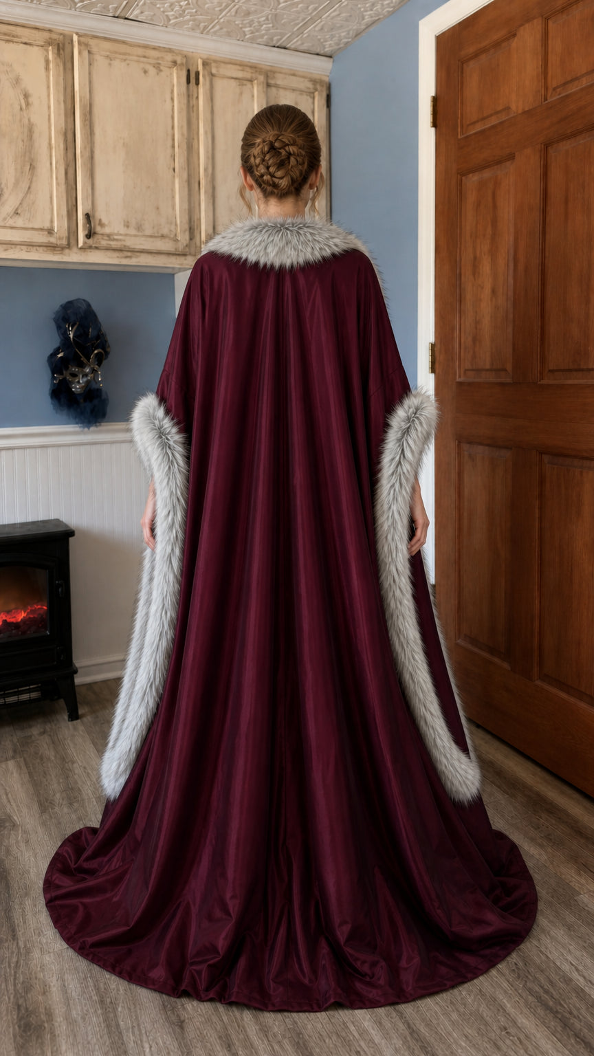 Rear view showing sweeping cloak of the burgundy medieval gown