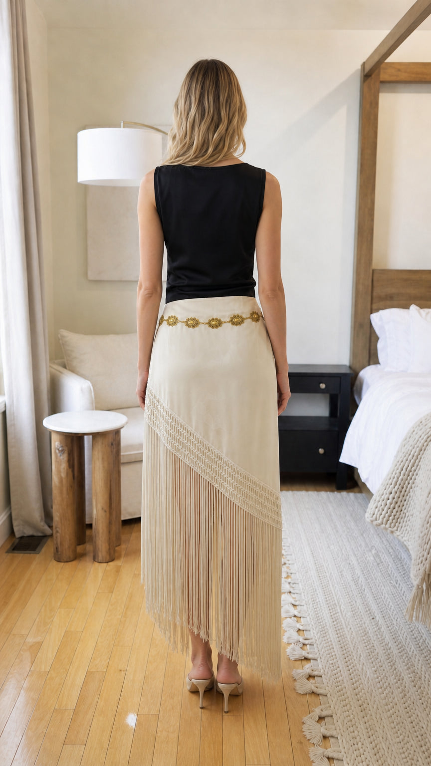 Back view of woman in beige fringe long skirt