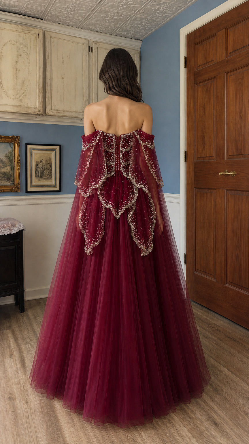 Back view showcasing the detailed layered tulle and cape on the burgundy gown