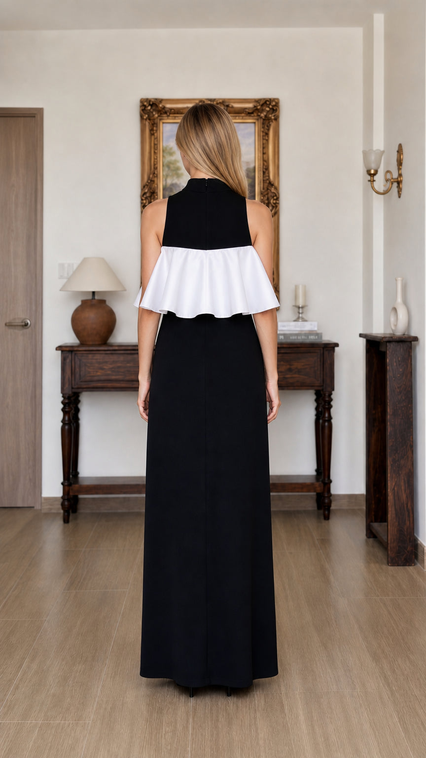 Back view of model wearing black and white ruffle maxi dress
