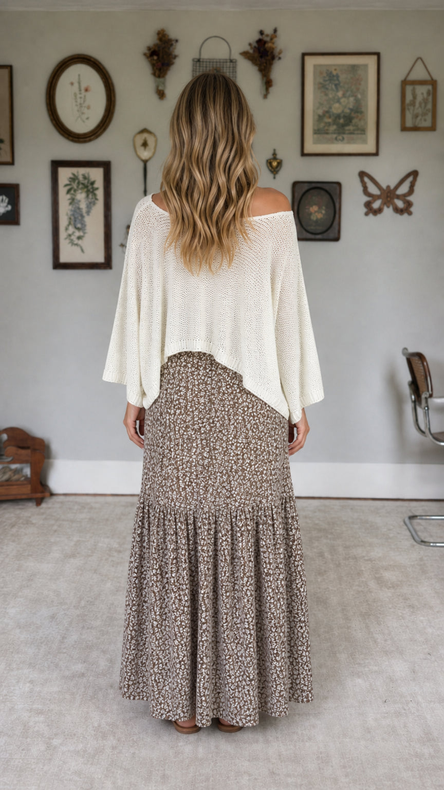 Model wearing white knit top and floral maxi skirt set, back view