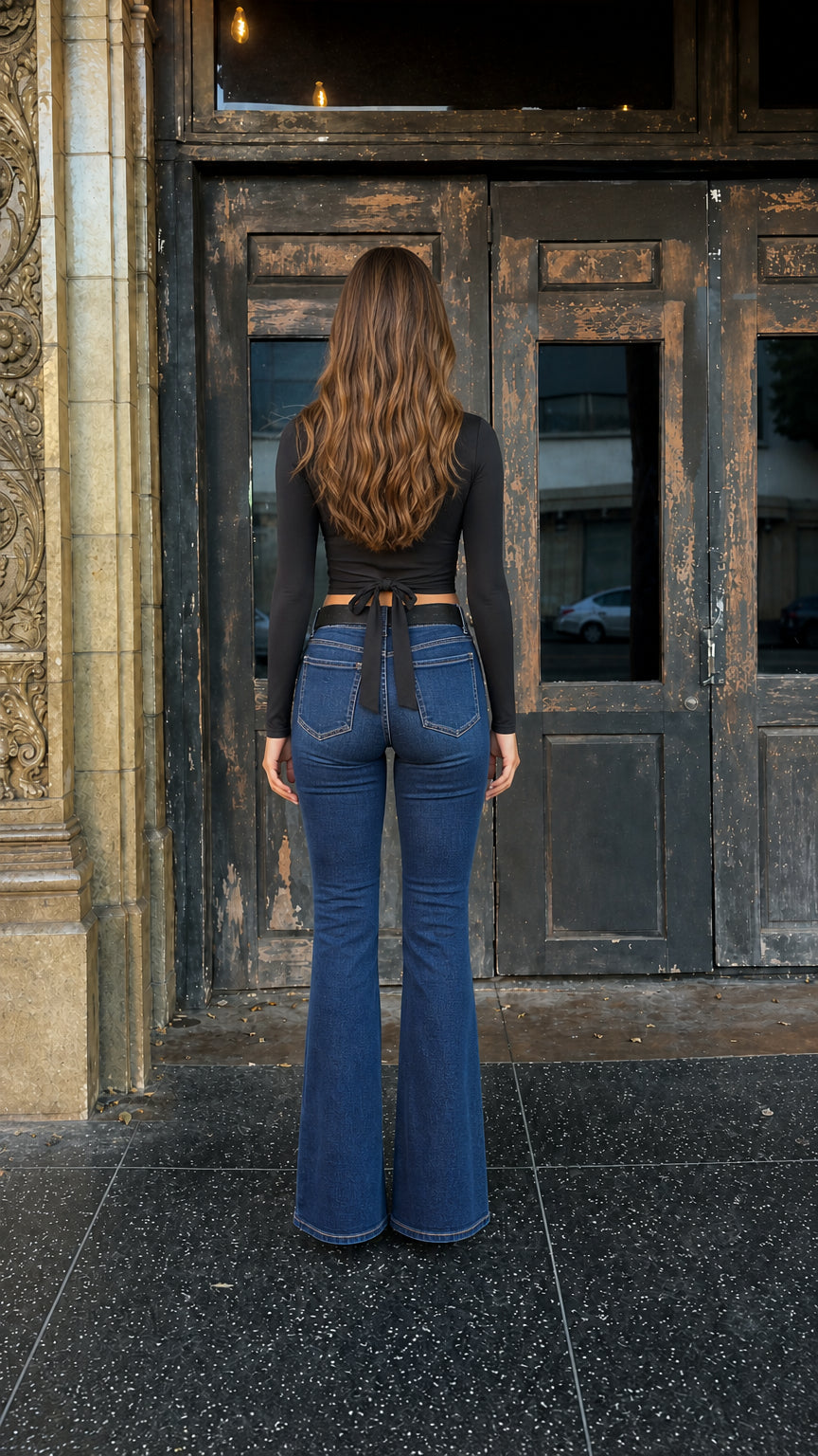 Back view of woman showing self-tie bow detail on black crop top
