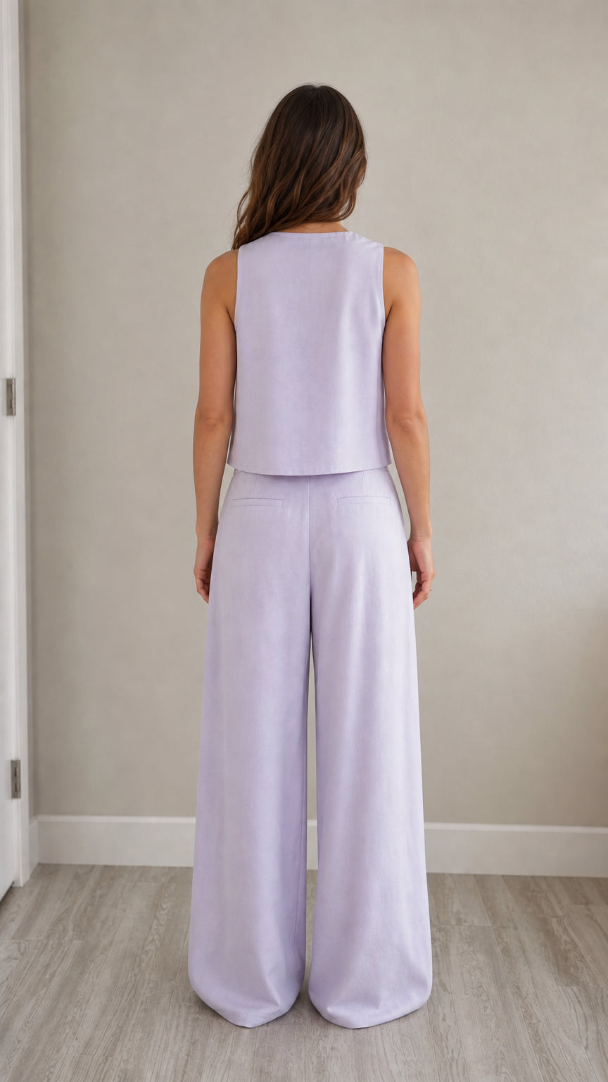 Back view of model wearing lavender vest and wide-leg pants