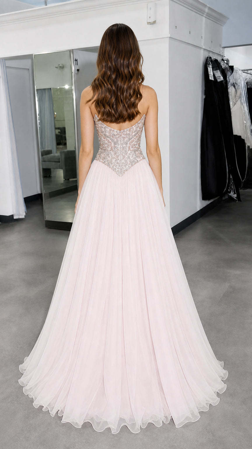 Back view of model showing lace-up and zip back details of pink gown