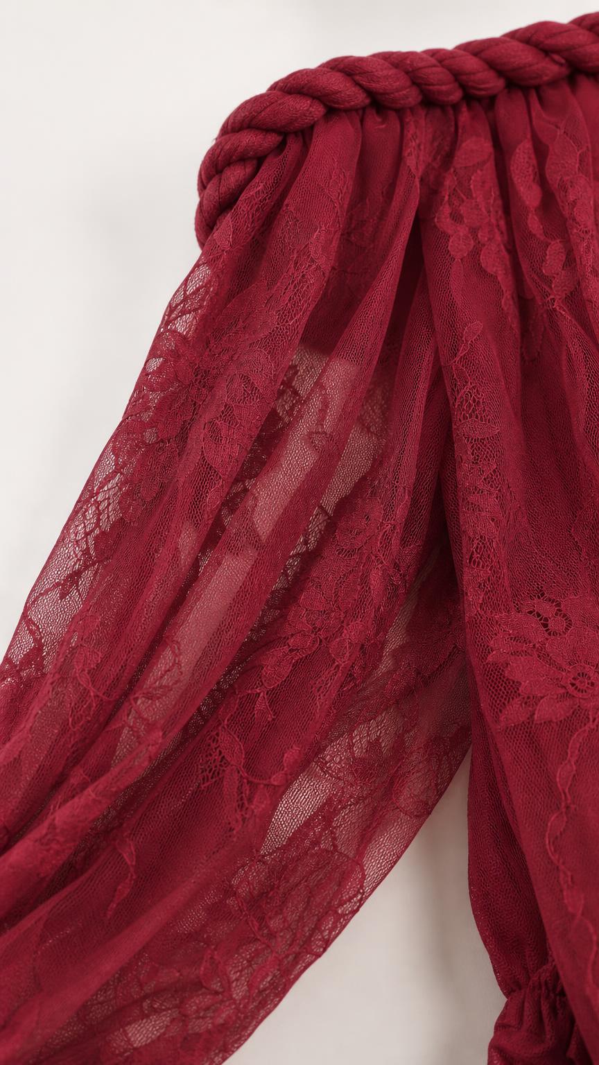 Close-up detail of braided neckline and lace texture