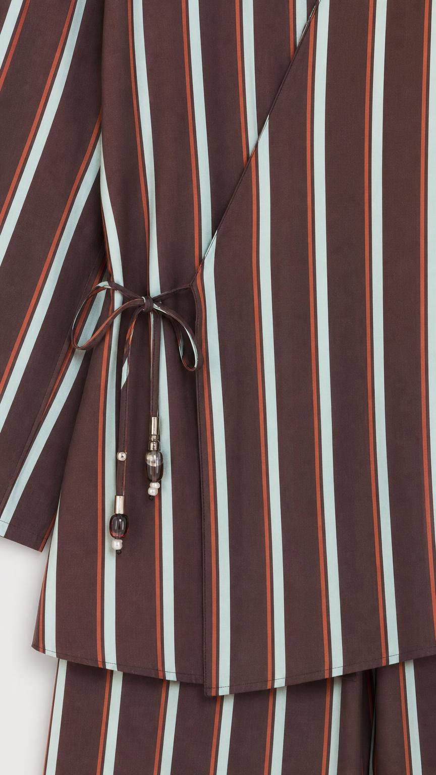 Close-up of wrap top side tie detail with beads