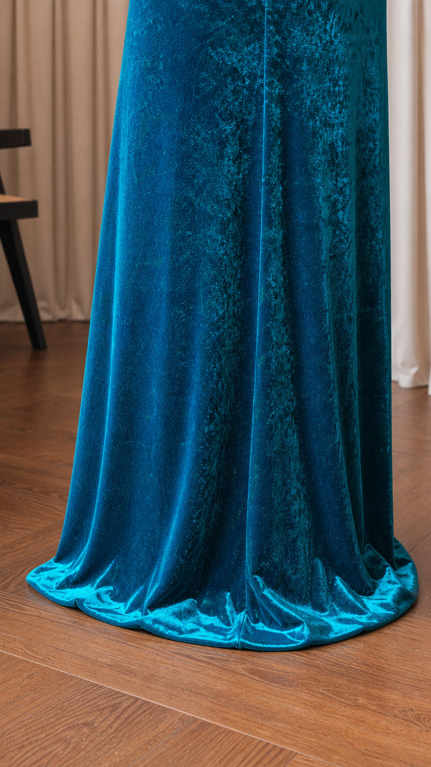 Close-up of floor-length hem on teal velvet dress