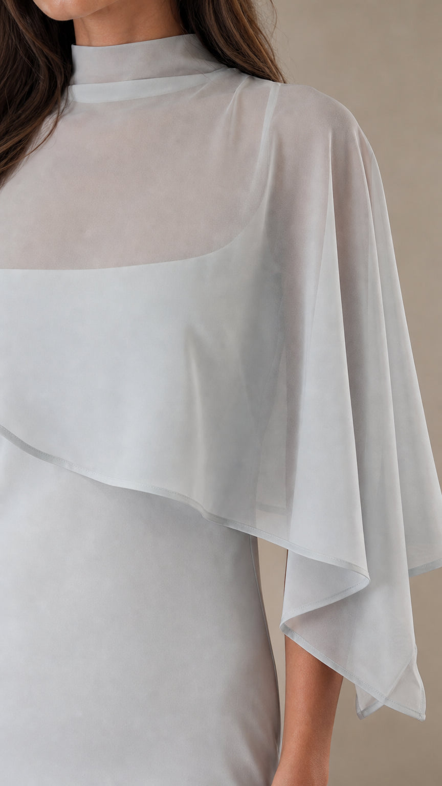 Close up of sheer cape overlay and mock neck detail