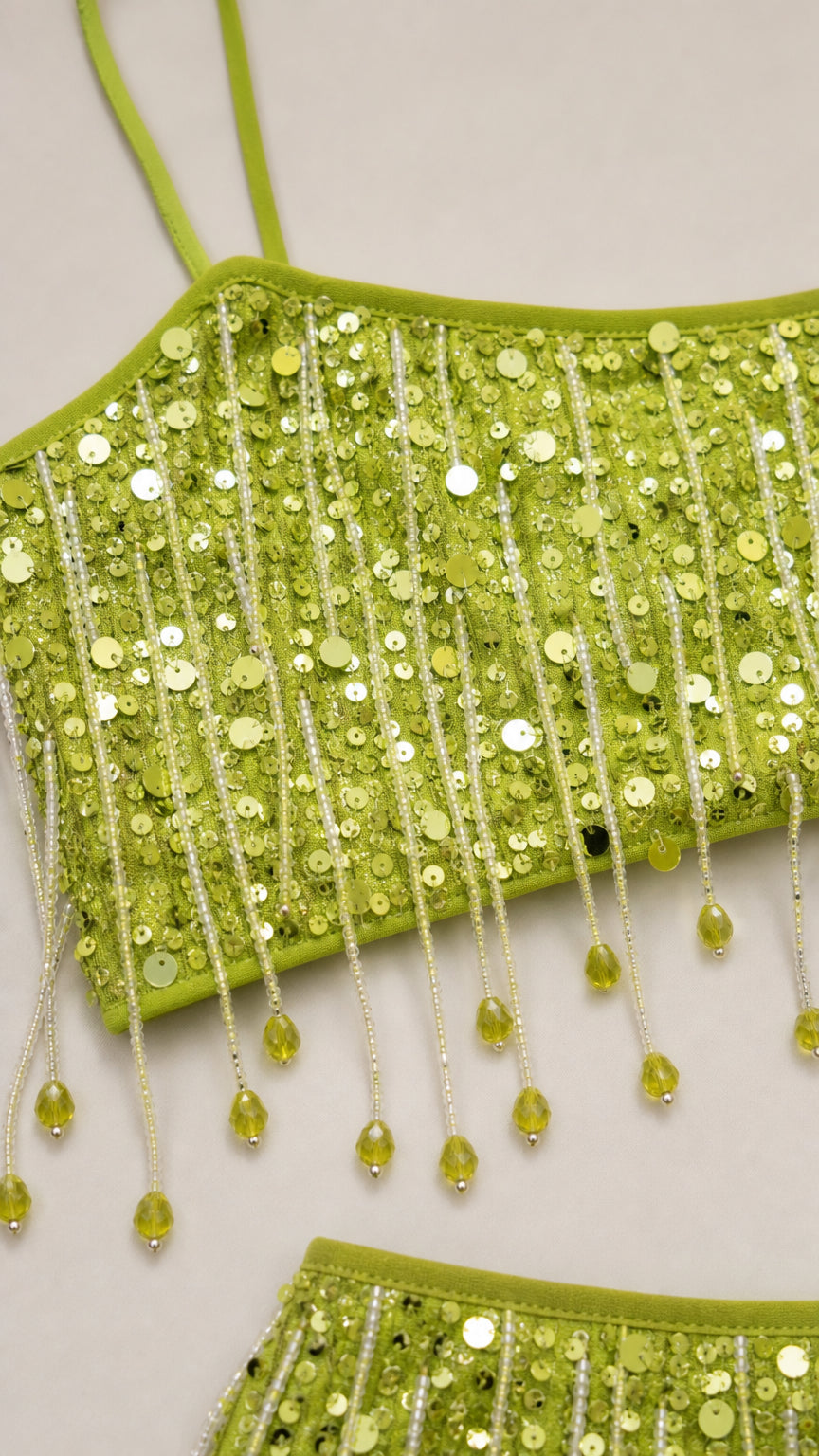 Close-up detail of lime green sequins and beaded fringe on crop top