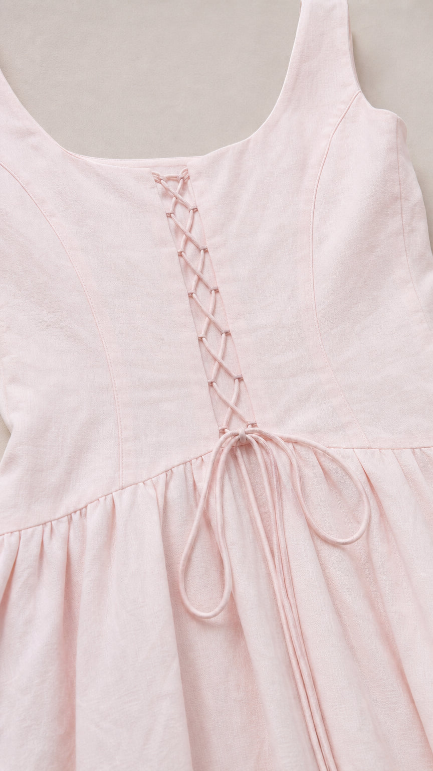 Close-up of square neckline and back lacing