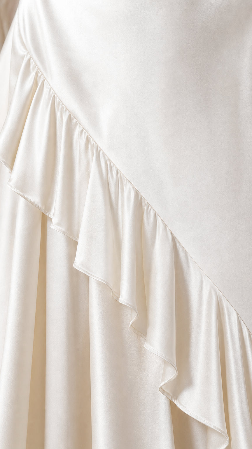 Close-up detail of the satin fabric and ruffle hem