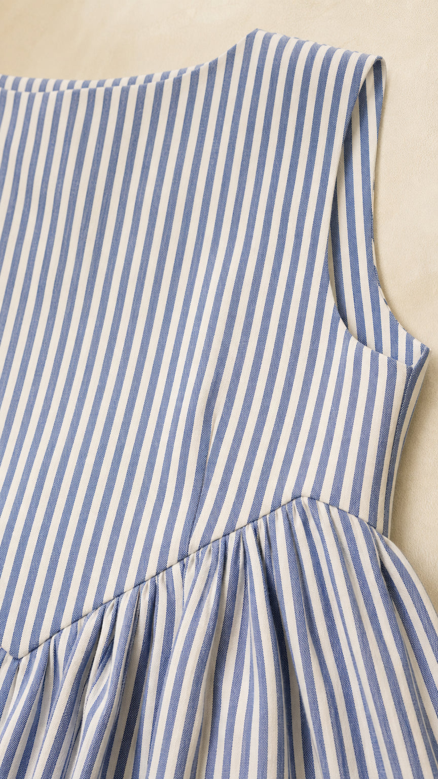 Close-up of fabric and dropped waist detail on blue striped dress