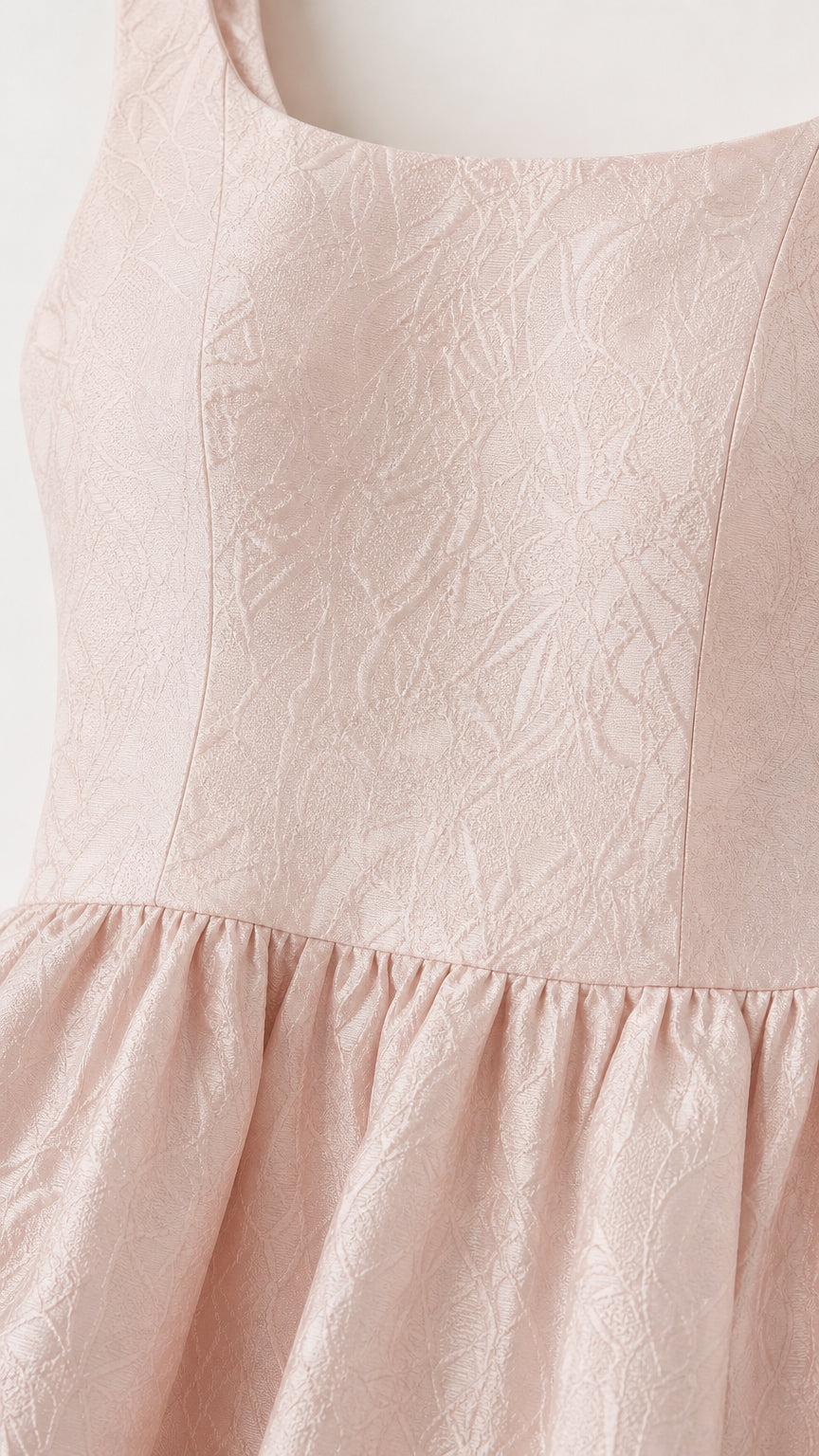 Close-up detail of fabric texture and square neckline
