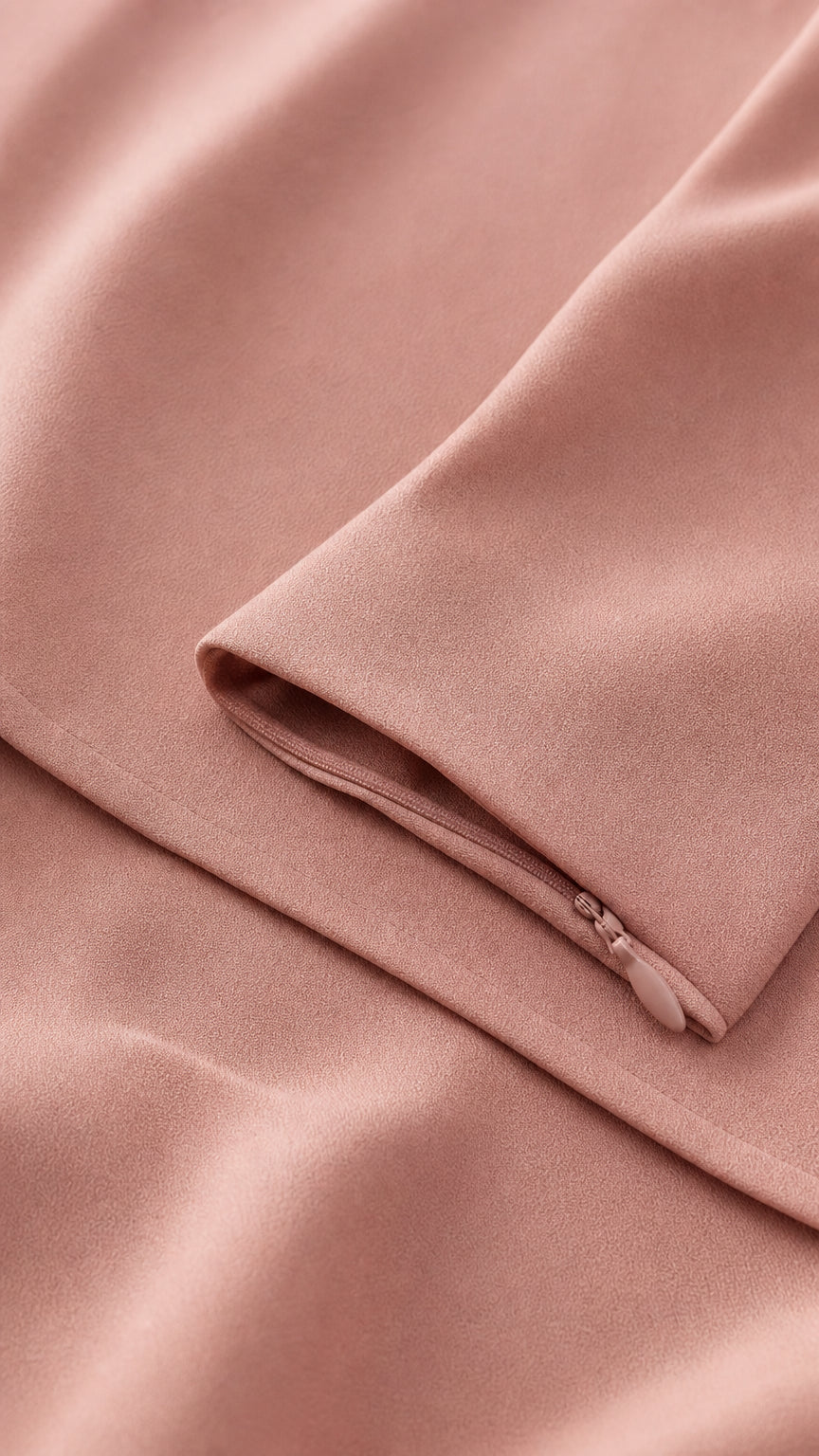 Close-up of smooth pink fabric and zipper detail
