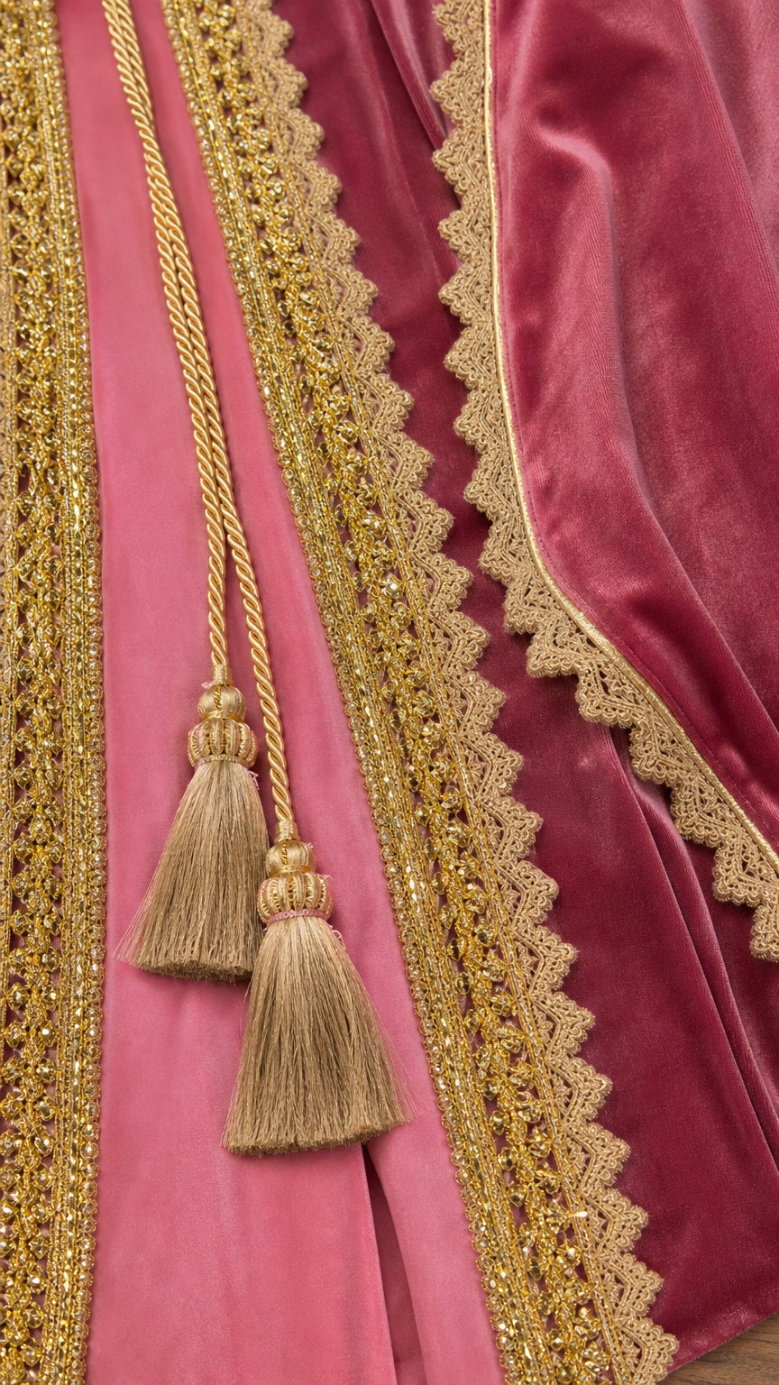 Close-up detail of the gold braided trim, tassels, and velvet texture