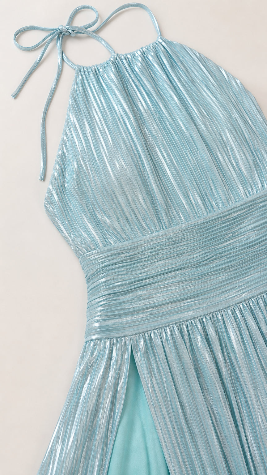 Close-up detail of light blue metallic pleated fabric and bodice
