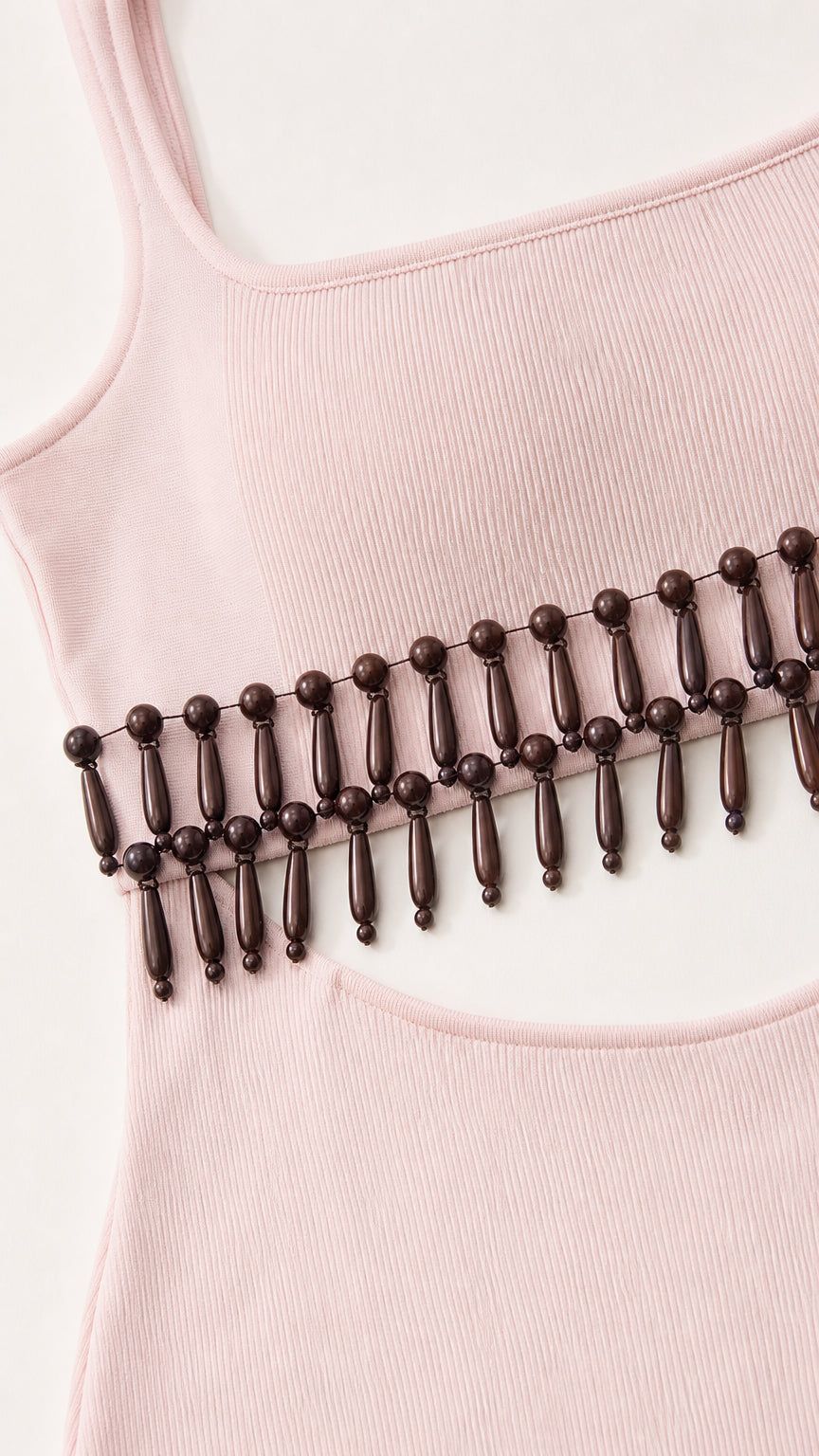 Close-up detail of scoop neck and wooden beaded waist fringe