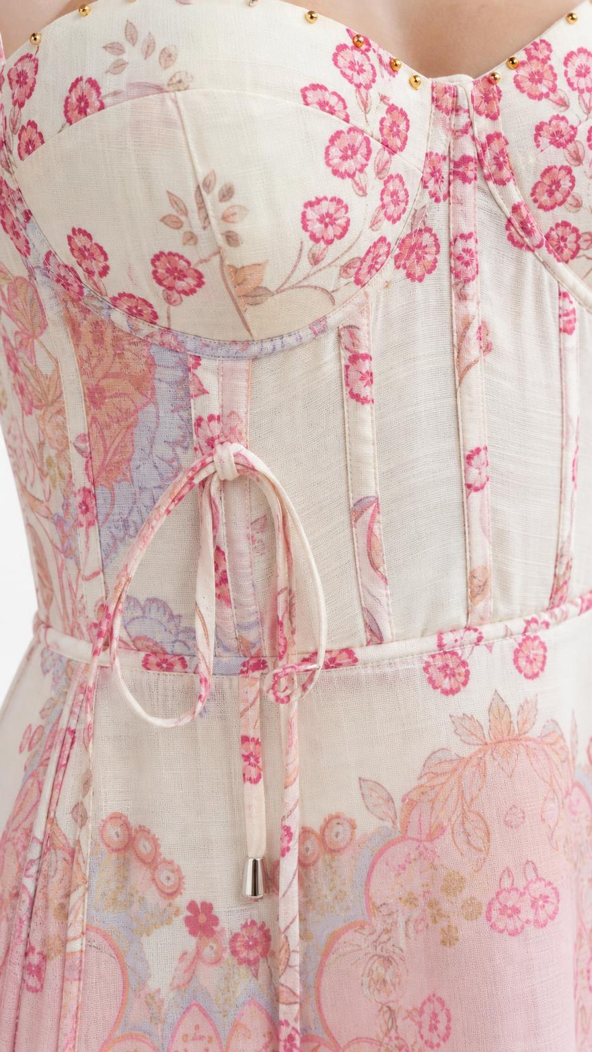 Close-up of structured corset bodice with floral pattern and tie details