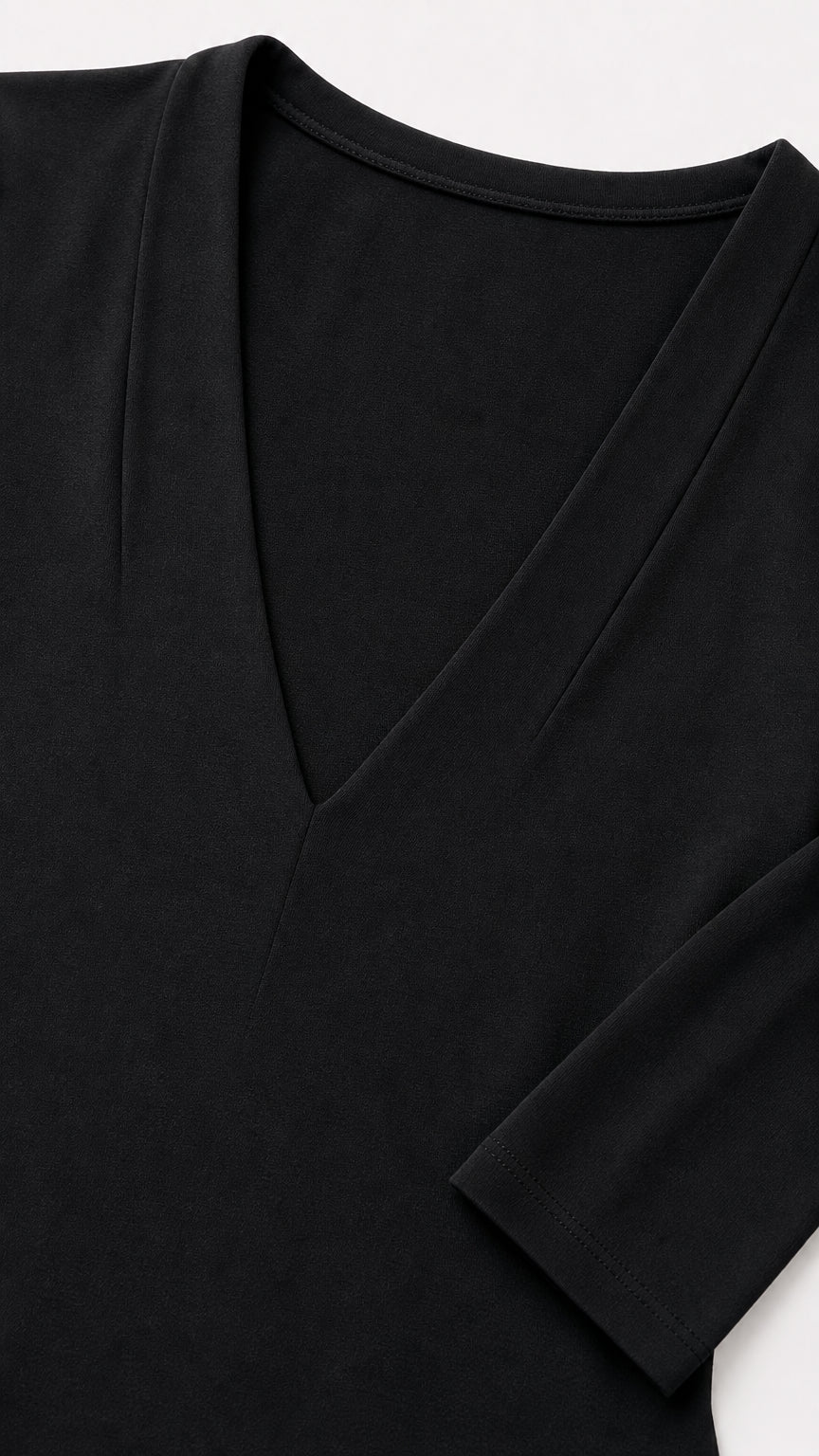 Close-up detail of the deep v-neckline and fabric texture