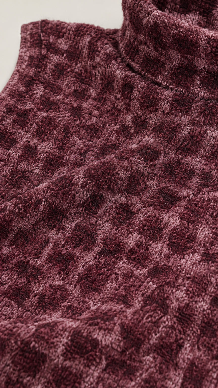 Close-up of fabric texture and mock neck detail in burgundy