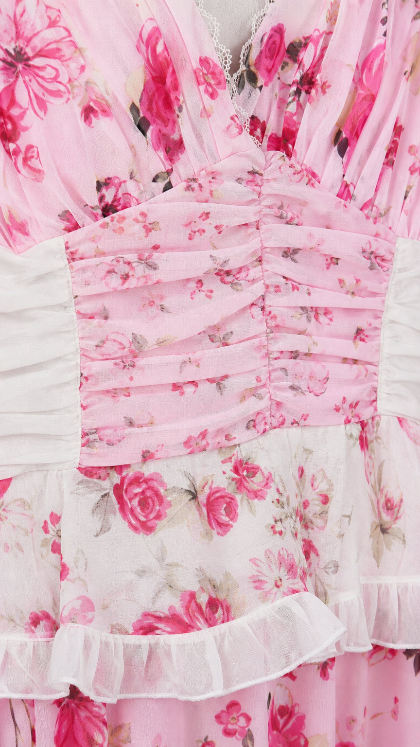 Close-up detail of ruched bodice and floral pattern on pink maxi dress