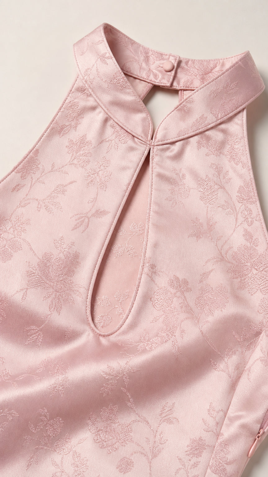 Close-up of halter neckline and floral jacquard texture