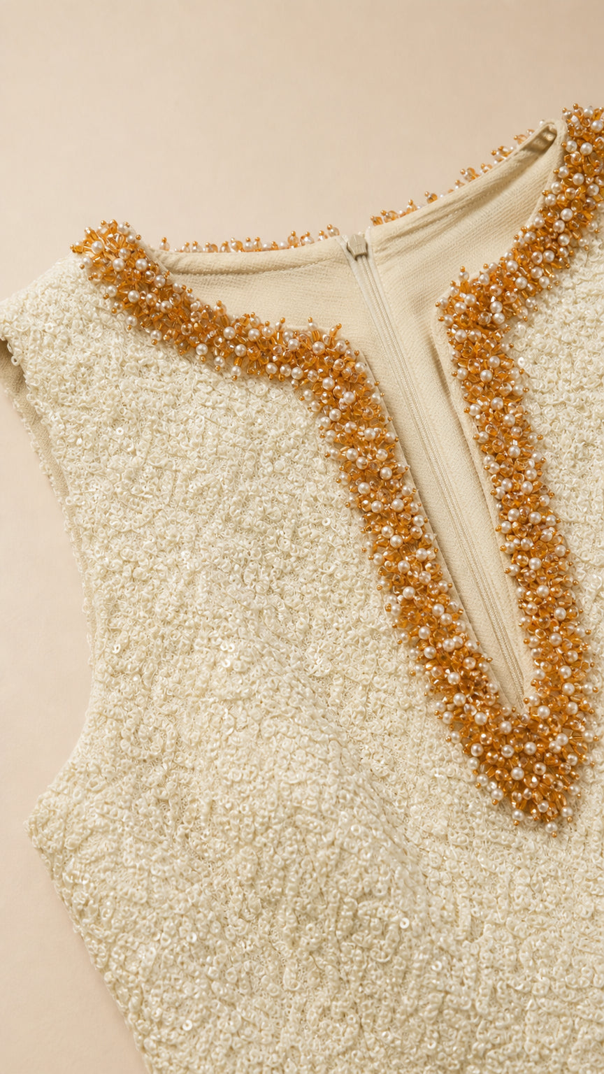 Close-up detail of the gold and bronze beaded V-neckline