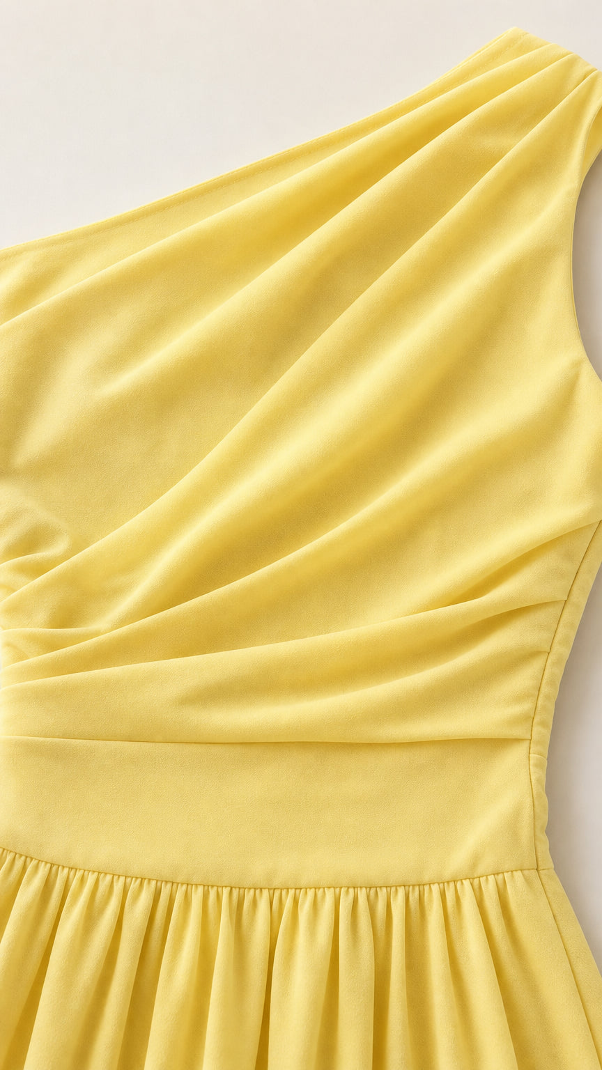 Close-up detail of yellow pleated bodice and fabric texture