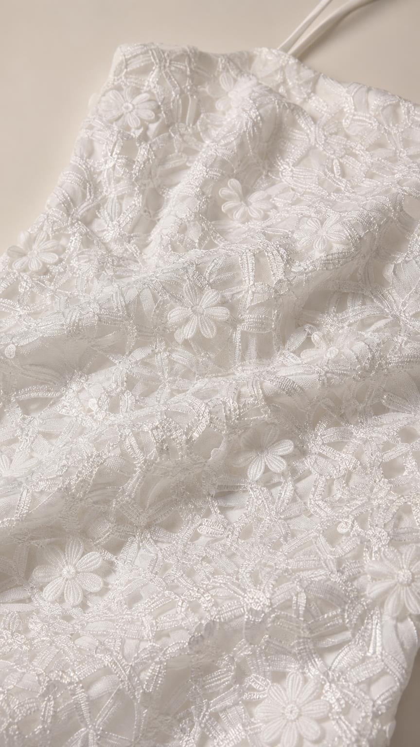 Close-up detail of white 3D floral lace fabric